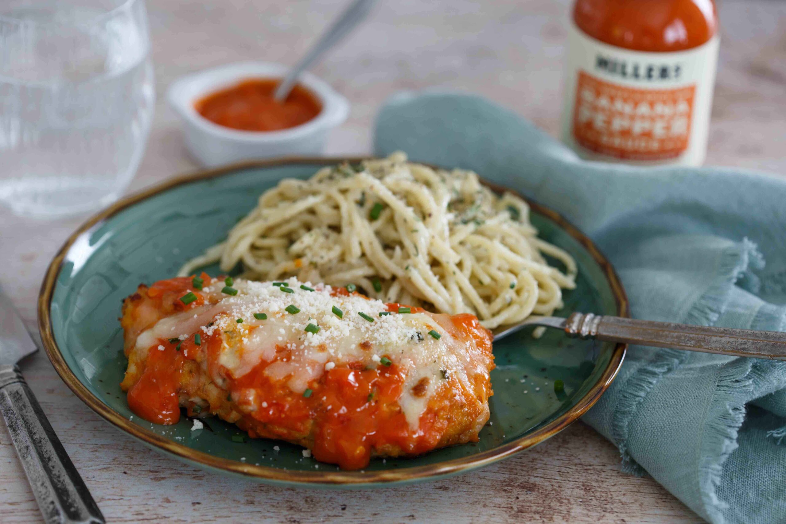 Spicy Buffalo Chicken Parmesan plated with Gorgonzola pasta