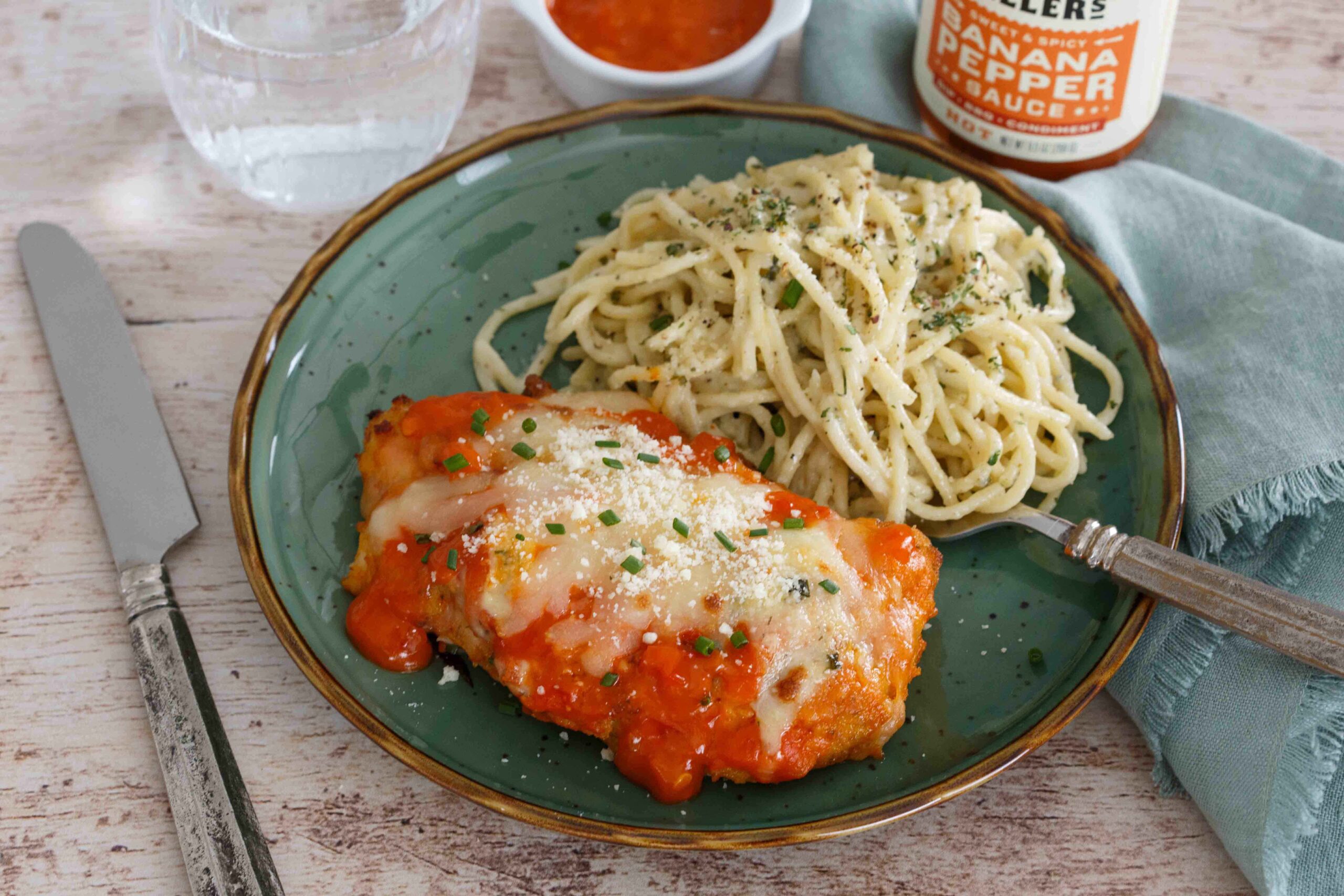 Spicy Buffalo Chicken Parmesan plated with Gorgonzola pasta