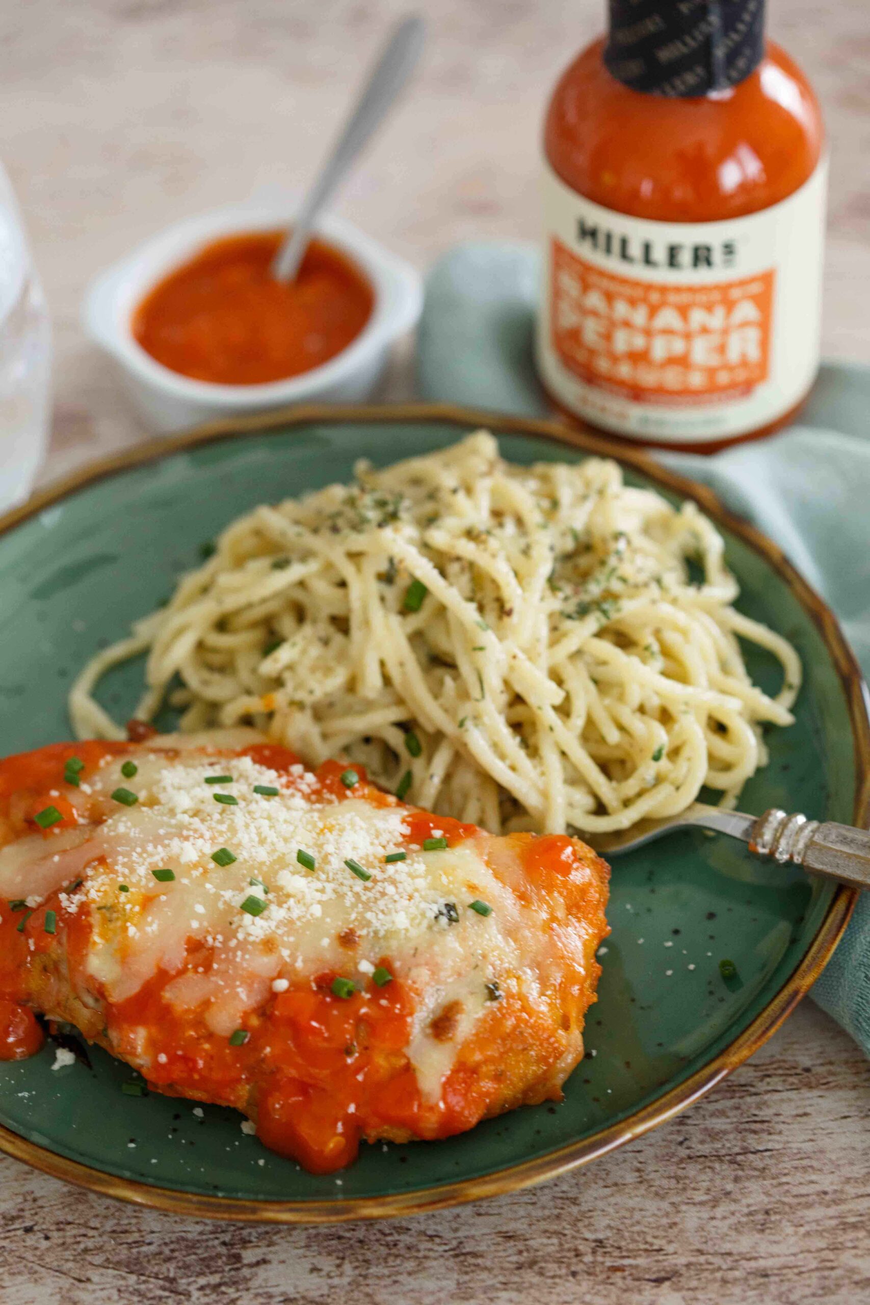 Spicy Buffalo Chicken Parmesan plated with Gorgonzola pasta