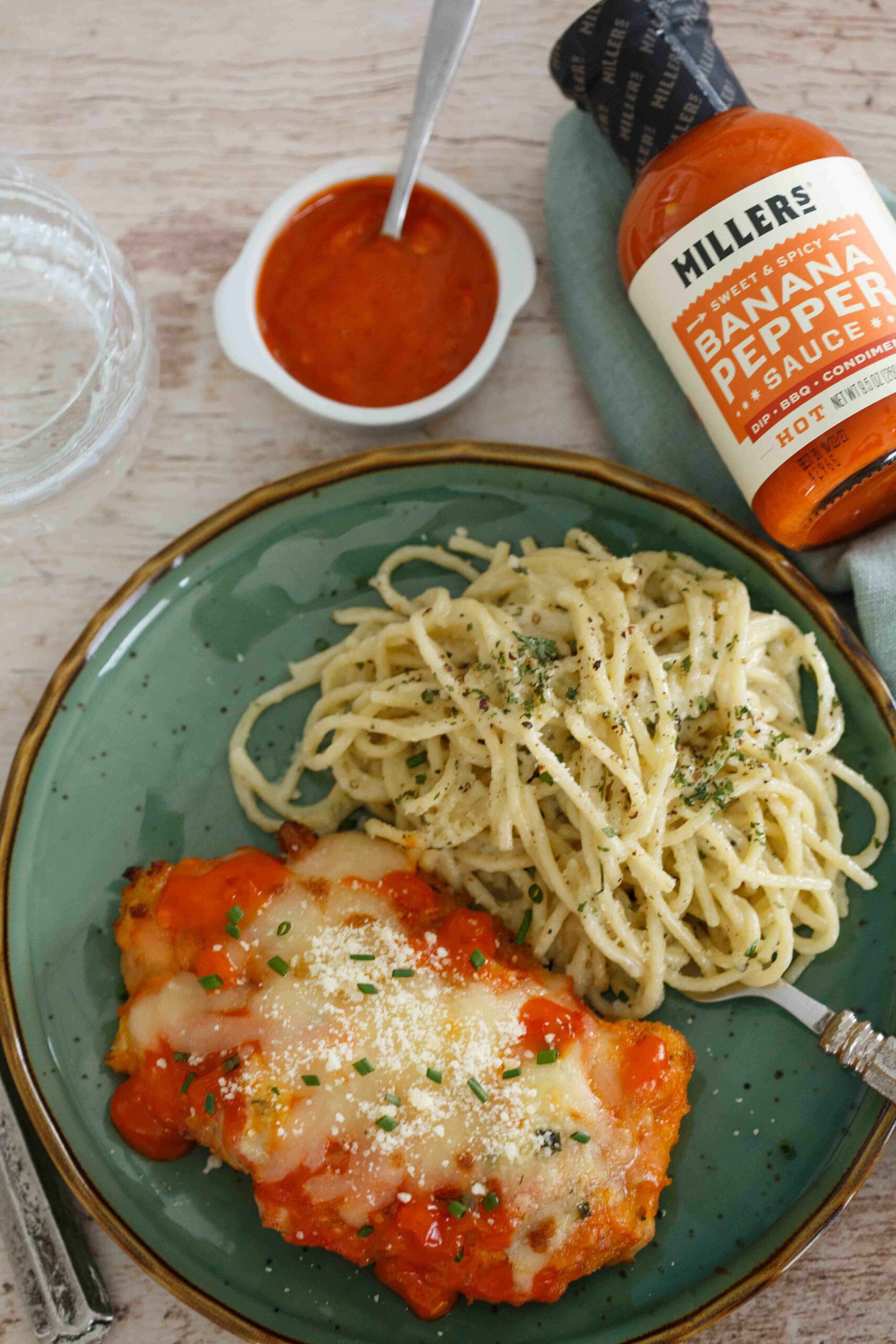 Spicy Buffalo Chicken Parmesan plated with Gorgonzola pasta