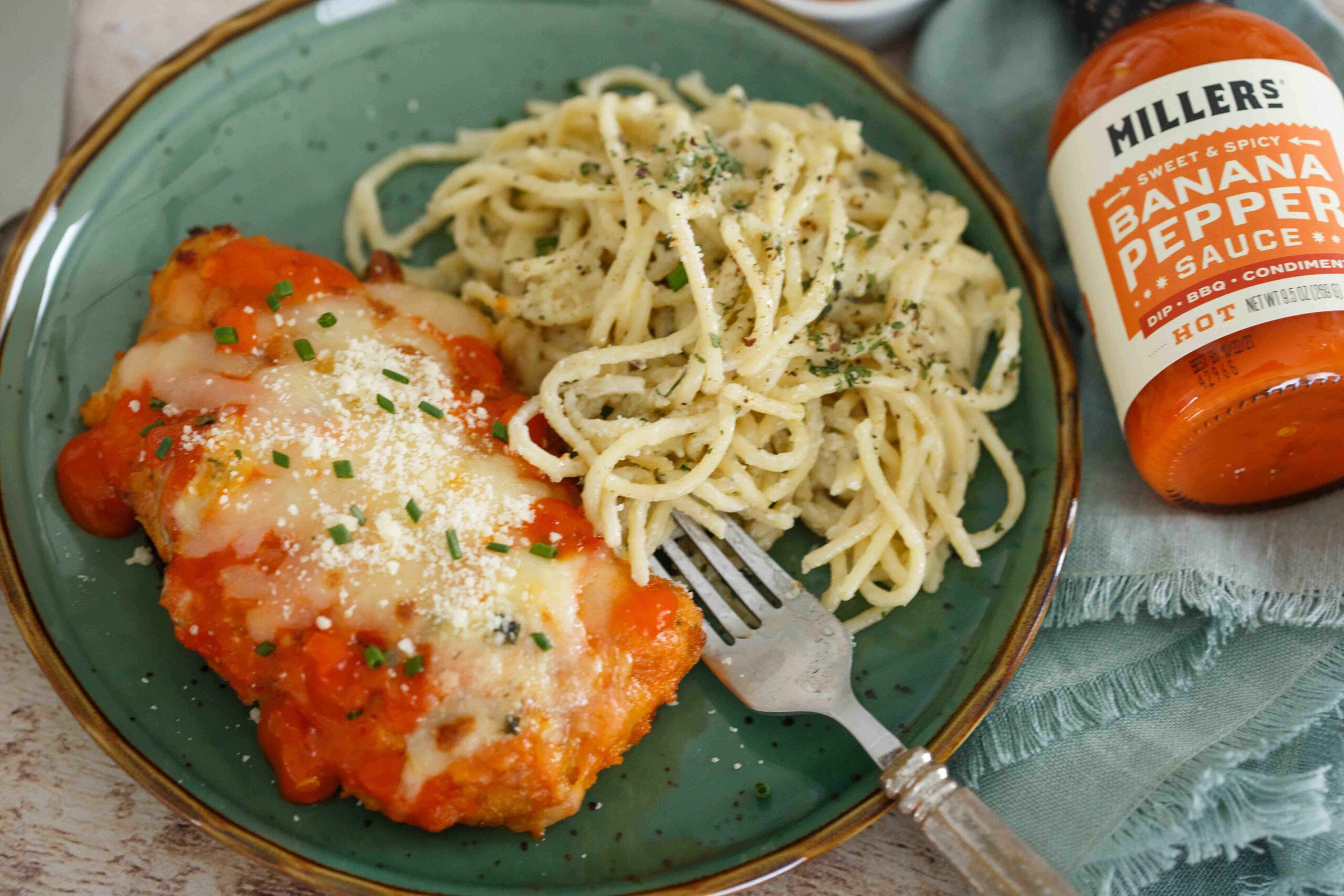 Spicy Buffalo Chicken Parmesan plated with Gorgonzola pasta