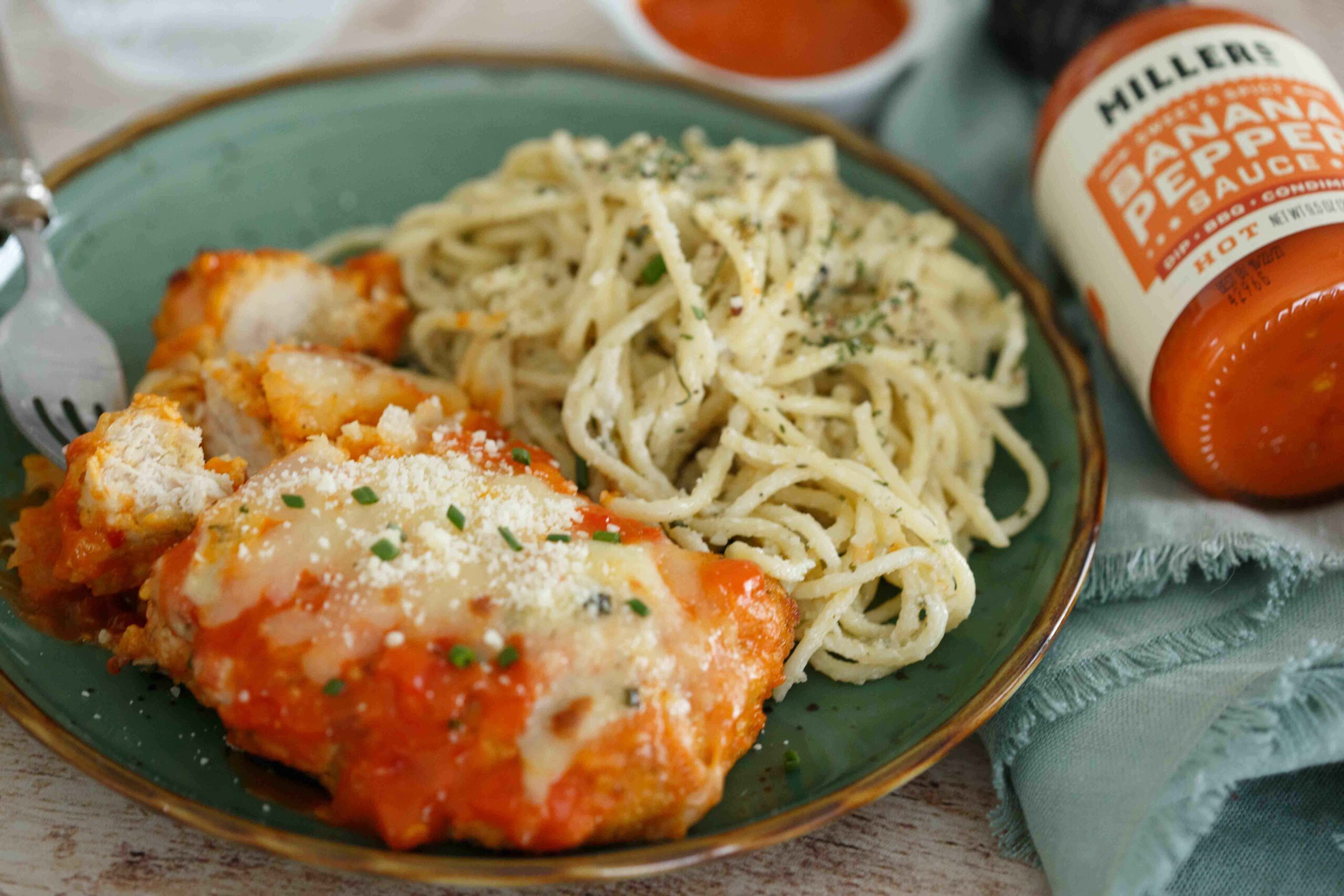 Spicy Buffalo Chicken Parmesan plated with Gorgonzola pasta