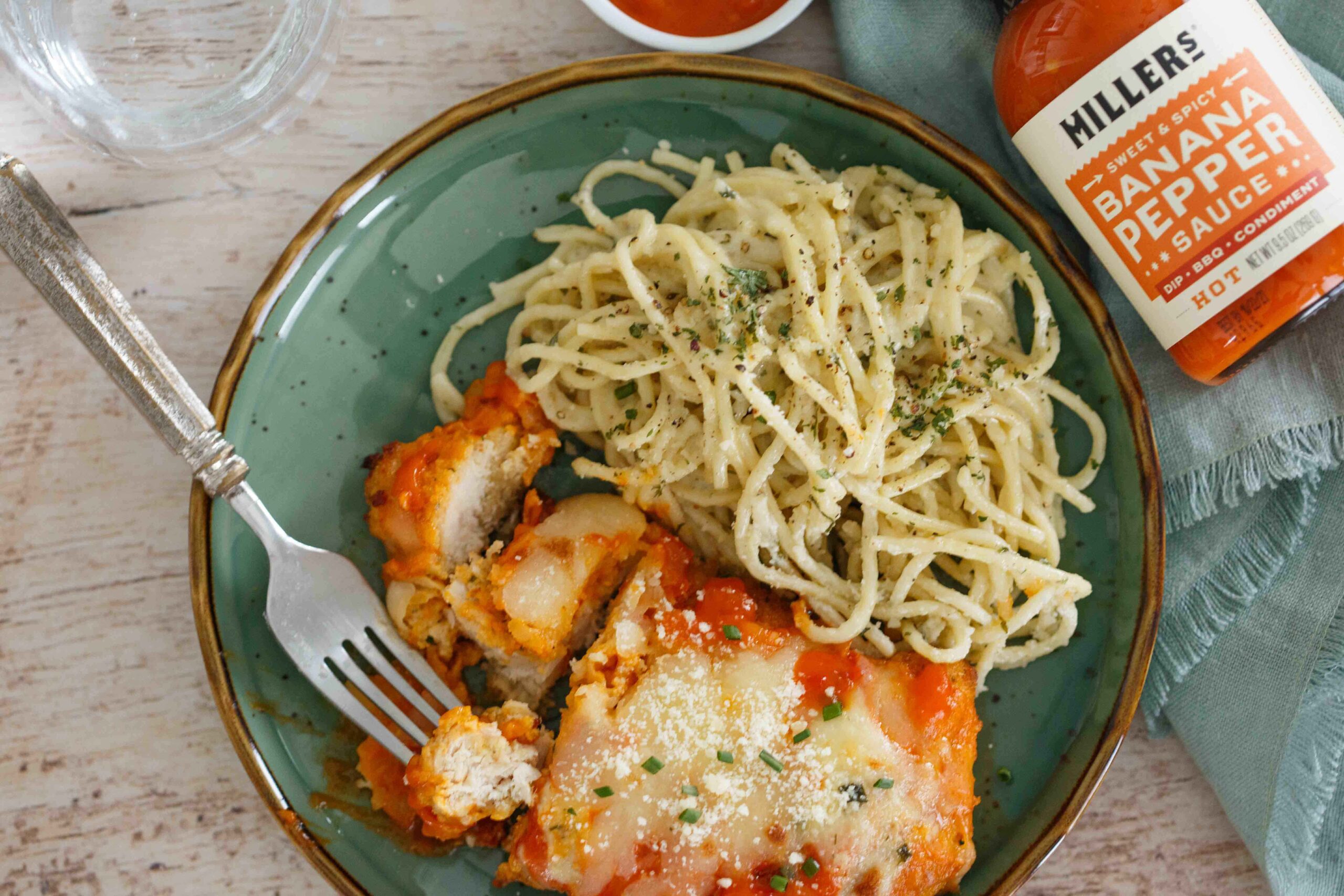 Spicy Buffalo Chicken Parmesan plated with Gorgonzola pasta